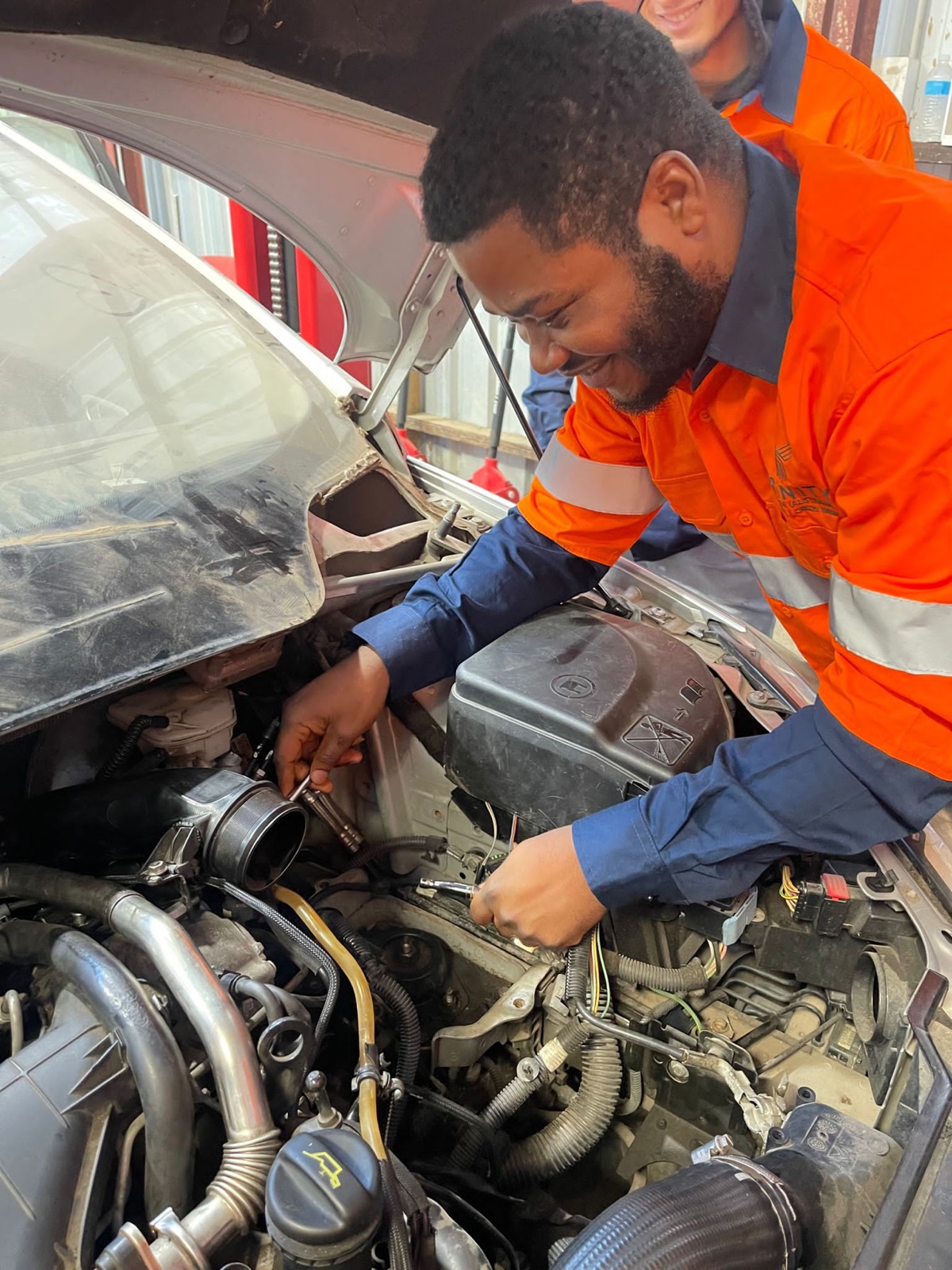 Crown Workshop mechanic carrying out repairs under a vehicle bonnet